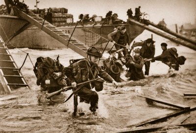 The first British troops disembark from the specially designed landing ladders, 6 June 1944 by English Photographer